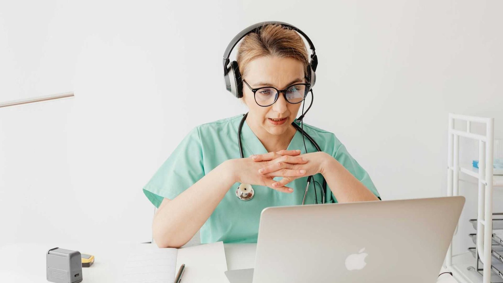 Doctor conducting a telehealth consultation on laptop with headset, representing digital healthcare & telehealth growth after Hims & Hers stock surged 57.4% following its Novo Nordisk partnership in the expanding $100B obesity and GLP-1 digital health market.