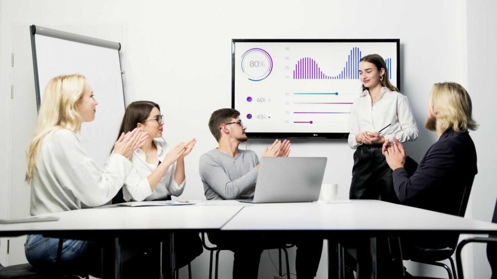 Business team reviewing HR analytics dashboard during a corporate meeting, illustrating Paycom’s $544M Q4 revenue, 10.2% growth signal, and evolving risk outlook in the HR software market.