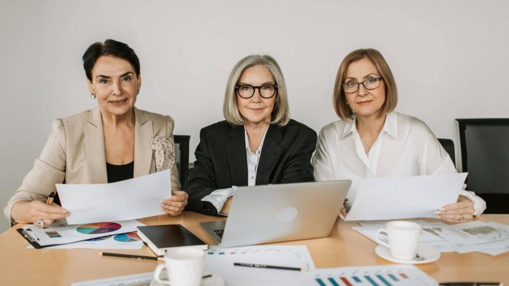 Three professional women reviewing financial charts, illustrating Allworth's $35B growth strategy and the $34T female wealth opportunity in the Great Wealth Transfer.